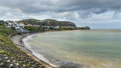 Penrhyn Bay: Plans to improve sea wall 'at risk of failure' put to public - BBC News