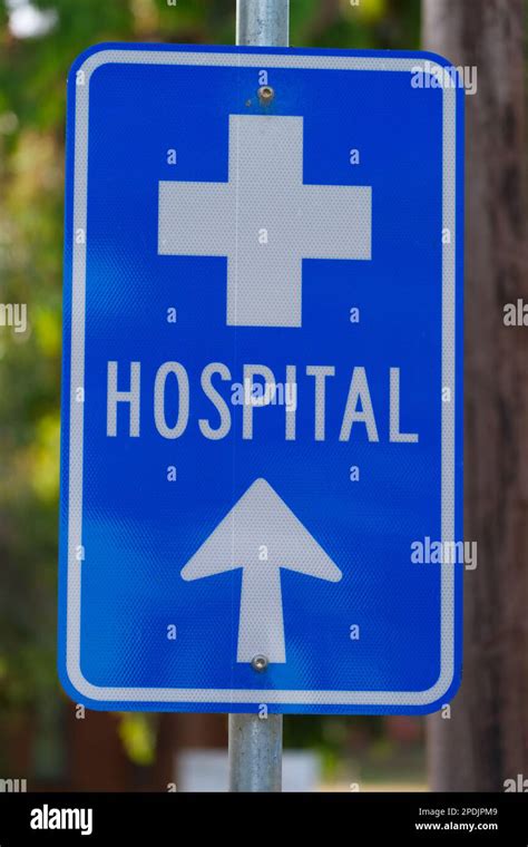 Blue and white hospital sign with arrow pointing to hospital ahead ...