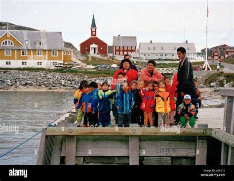 Greenland, Capital city of Nuuk, local people standing on jetty Stock ...