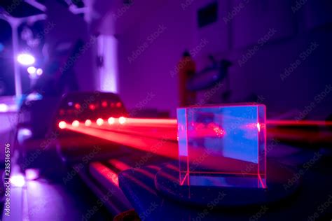 Experiments with lasers in the optics lab. Red laser on optical table ...