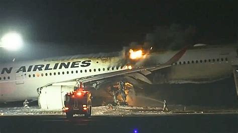 Japan Airlines plane with 367 onboard catches fire on runway at Tokyo Airport