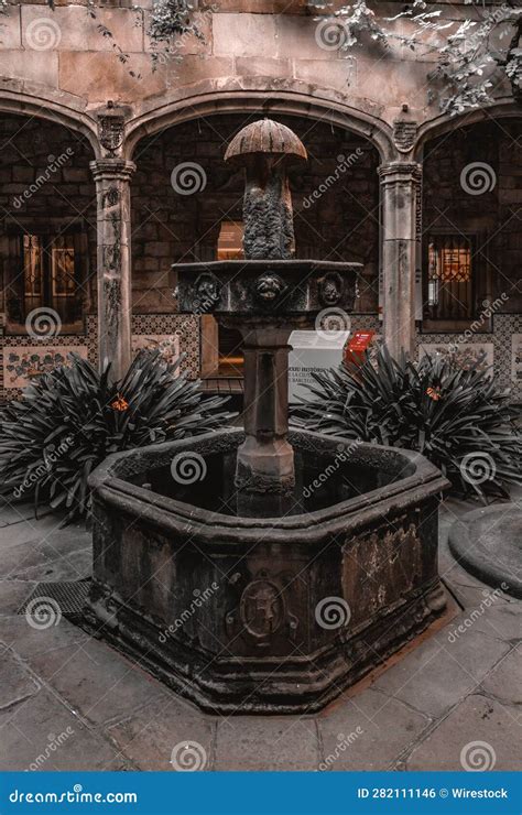 Old-fashioned Water Fountain with Flowerpots in a Stone-paved Outdoor ...