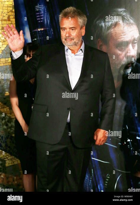 French director Luc Besson waves at a premiere for his movie, Lucy, in ...