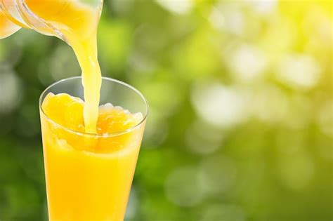 Premium Photo | Pouring orange juice