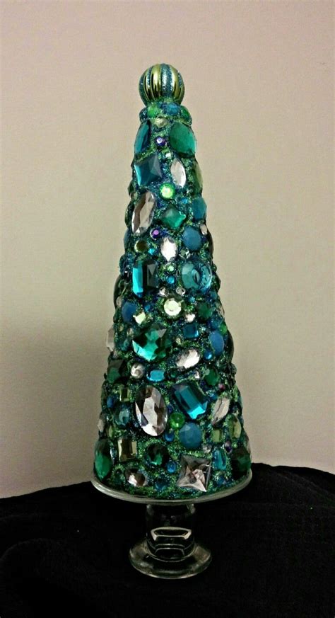 Styrofoam tree with craft jewels that are hot glued on. Finish with glitter glue between ...