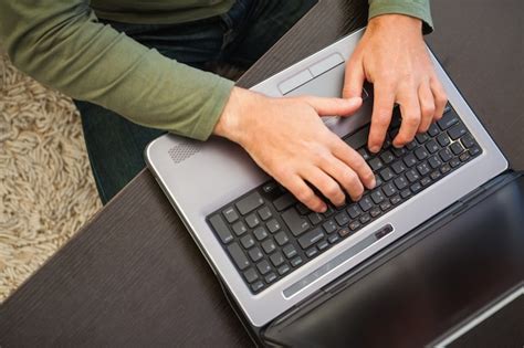 Premium Photo | High angle view of a man typing on laptop