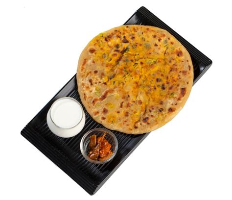 Premium Photo | Indian breakfast dish paneer paratha serve with curd or chutney