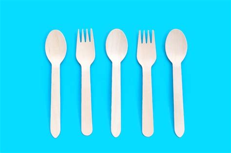 Premium Photo | Wooden spoon fork on blue background