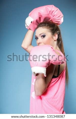 Female boxer model wearing big fun pink gloves playing sports boxing ...