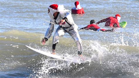 Frigid weather doesn't stop Santas surfing off Florida coast