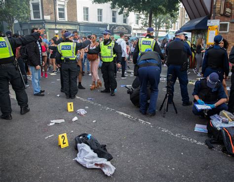 Police at the scene of a stabbing at Notting Hill Carnival, London. 28 ...