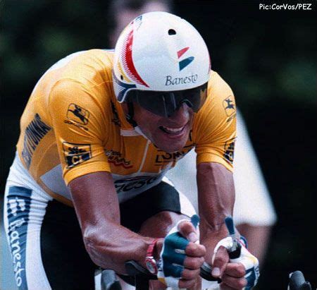 a man riding on the back of a bike wearing a helmet and holding onto ...