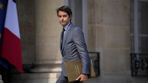 France's new prime minister unveils cabinet with several familiar faces