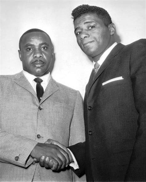 Sonny Liston and Floyd Patterson shake hands. This photo was taken at a Writers Dinner on ...