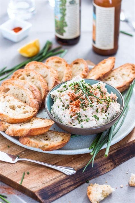 Smoked trout dip presented in a bowl sprinkled with chives and with ...