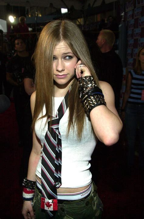 a woman with long hair wearing a tie and gloves