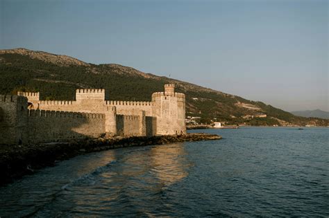 Medieval fortress on seashore against grassy hill · Free Stock Photo