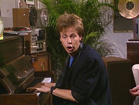 a man making a surprised face while playing the piano