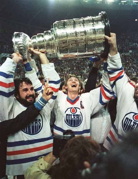 Wayne Gretzky and a bearded Paul Coffey hoist the Stanley Cup on May 19 ...