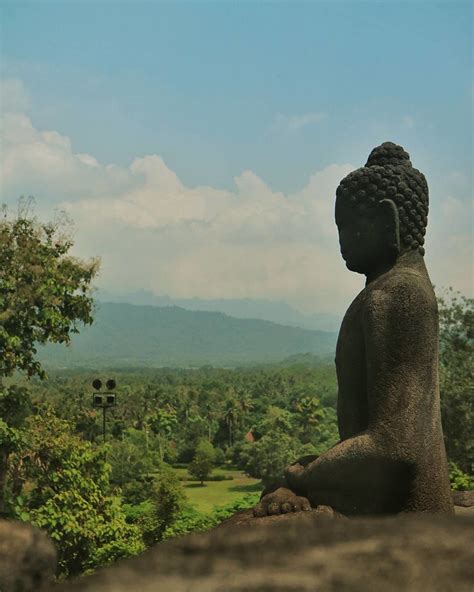 A statue on the Borobudur Temple watching the world go by.… | Flickr