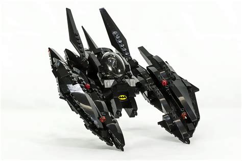 a lego model is shown on a white surface with black parts and red lights,