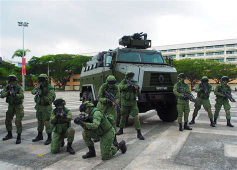 Singapore Army soldiers posing in front of a Peacekeeper protected response vehicle [4483 x 3220 ...