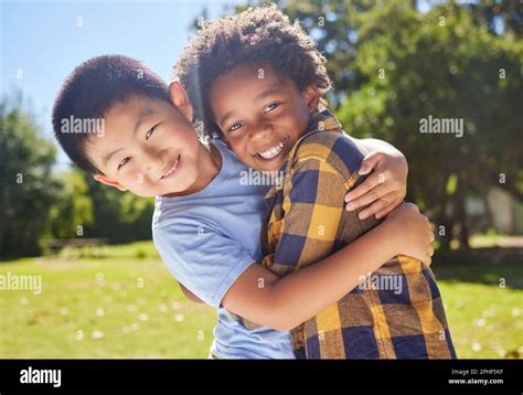 Portrait, children and friends hugging in a park together for fun ...