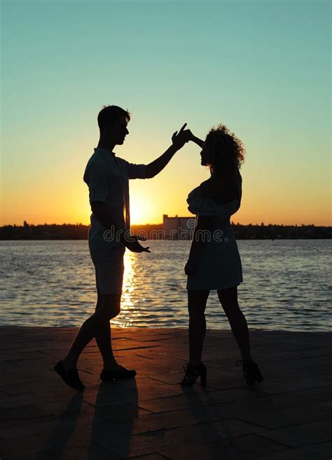 Happy Couple Dancing at Sunset on the Beach Stock Photo - Image of ...