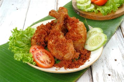 Premium Photo | Ayam goreng serundeng, fried chicken sprinkled with grated coconut with curry ...