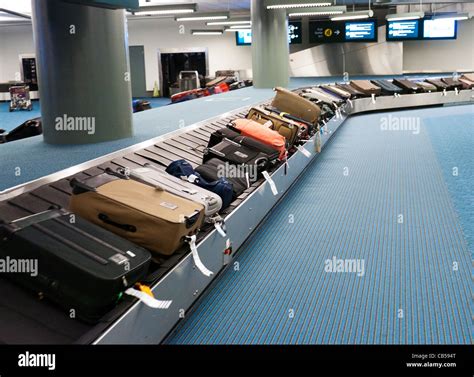 Suitcases on a luggage carousel at an airport Stock Photo - Alamy