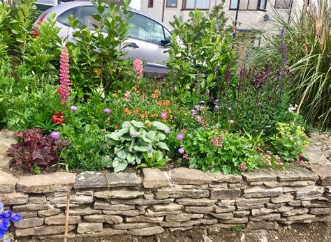 Raised stone garden flower bed | Garden design, Garden flower beds, Garden stones