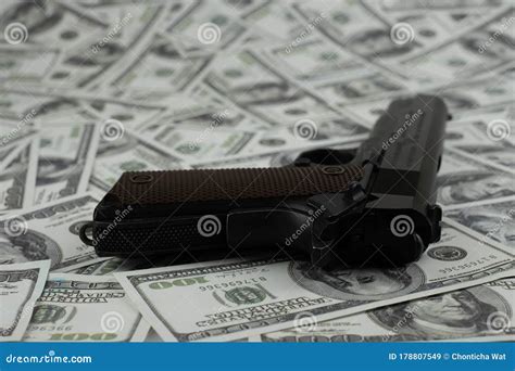 Gun Pistol On Stack Money 100 Dollars Background Stock Image ...