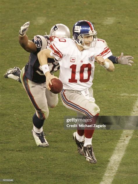 Eli Manning of the New York Giants scrambles for an opening against ...