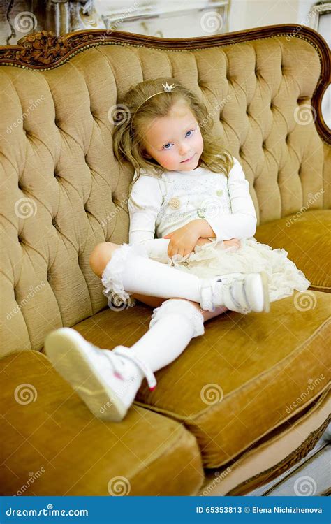 The little girl on a sofa stock image. Image of fashion - 65353813