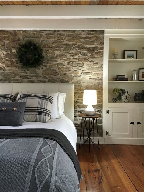 Exposed original stone accent wall behind the headboard. Stone House Revival - Season … | Stone ...