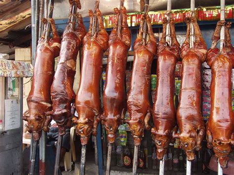 Roasted pigs ("Lechon") for sale in the markets at Quezon City ...