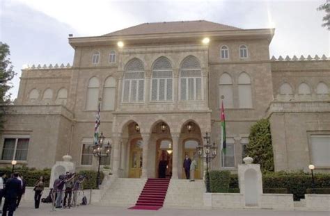 a large building with stairs leading up to it and people standing in ...