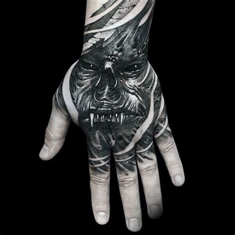 Creepy horror style black ink hand tattoo of monster face - Tattooimages.biz