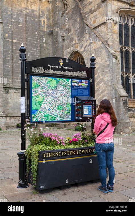 Street signs to different destinations. Town centre map of Cirencester ...