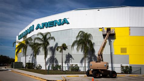 Transforming Hertz Arena: Workers painting arena yellow in Estero