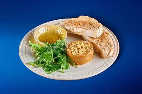 Premium Photo | Fresh homemade goose liver pate with baguette, arugula ...