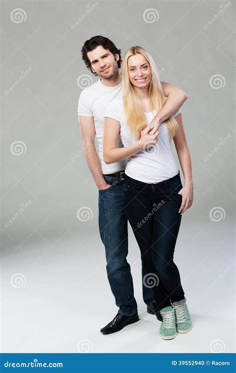 Casual Young Couple Posing Arm in Arm Stock Photo - Image of lady, girl ...