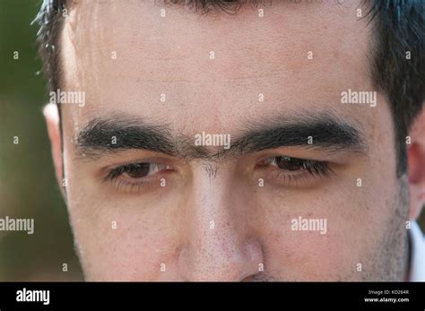 Close up of man with unibrow Stock Photo - Alamy