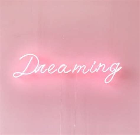 a pink neon sign that says dreaming