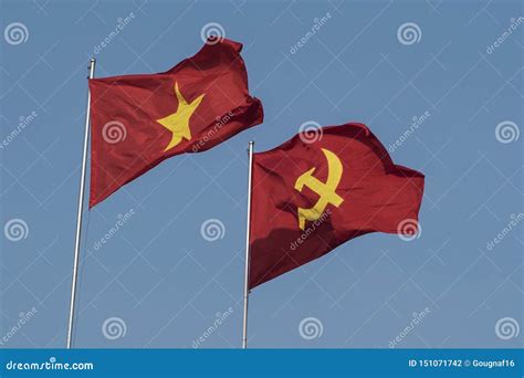 Vietnamese and Communist Flags in the Wind on a Blue Sky Stock Photo ...