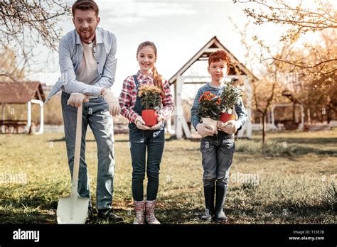 Happy family for their man in village Stock Photo - Alamy