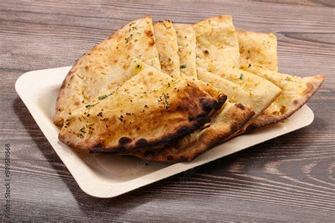 Indian tandoori bread - Garlic naan Stock Photo | Adobe Stock