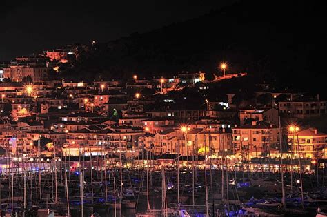 boats anchored at cesme marina and houses at the background at night. | Cesme, Boat, Boat anchor