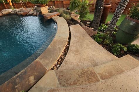 Salt finish concrete pool decking with natural stone accents. By: Outdoor Signature in Argyle ...