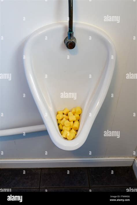 Yellow Urinal deodorizer blocks or urinal cakes in a men's urinal Stock Photo - Alamy